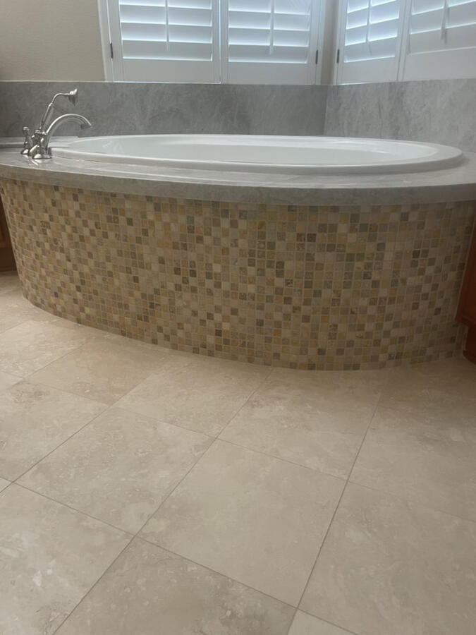 Travertine bathroom floor , mosaic on tub face and granite top